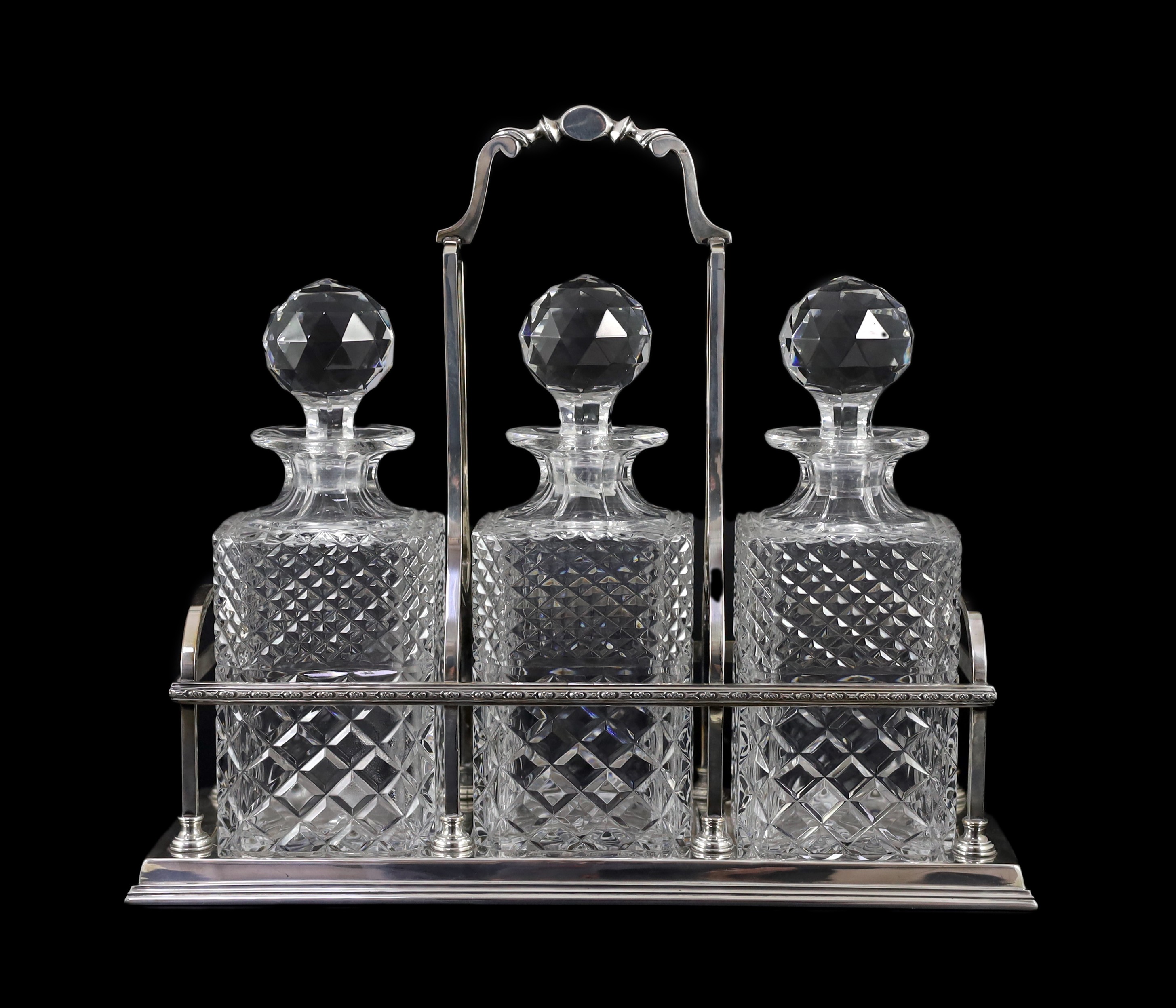 A modern silver three bottle rectangular decanter stand, by C.J. Vander Ltd